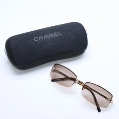 Mint condition CHANEL rimless glasses with side Coco mark, brown lenses, rhinestones, and gold hardware, 4093-B, size 56.◻16 130 Used 4a010062
