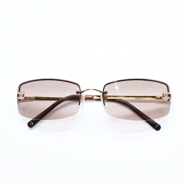 Mint condition CHANEL rimless glasses with side Coco mark, brown lenses, rhinestones, and gold hardware, 4093-B, size 56.◻16 130 Used 4a010062