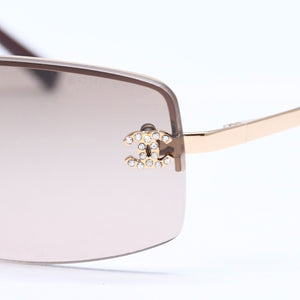 Mint condition CHANEL rimless glasses with side Coco mark, brown lenses, rhinestones, and gold hardware, 4093-B, size 56.◻16 130 Used 4a010062