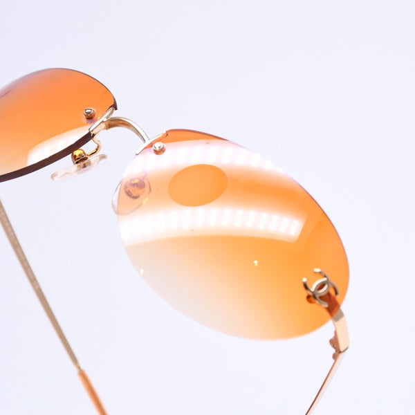 CHANEL rimless sunglasses with side Coco mark, orange lenses, and gold hardware, model number 4013 c.125/56, size 59.◻16 130 Excellent condition Used 4a010063